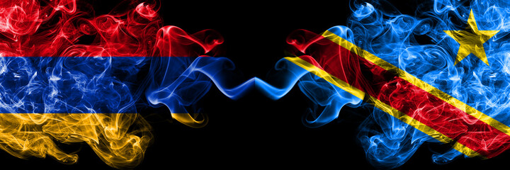 Armenia vs Democratic Republic of the Congo smoky mystic flags placed side by side. Thick colored silky abstract smoke flags