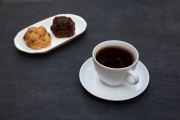 Top view of tea and handmade cookie on black table