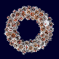 Traditional Christmas wreath of white pine cones and red beads isolated on dark blue background with copy space. Christmas wreath for design template greeting cards, invitations, advertising.