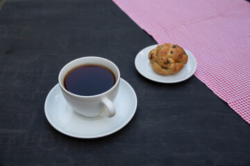 Top view of tea and handmade cookie on black table