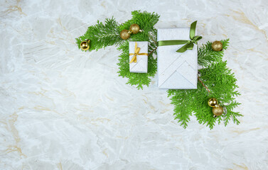Weihnachtsdekoration ,it Geschenk, Sternen, Tannengrün und Weihnachtskugeln auf marmoriertem...