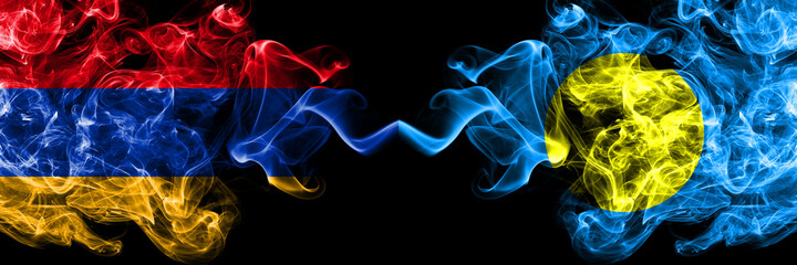 Armenia vs Palau, Palaulan smoky mystic flags placed side by side. Thick colored silky abstract smoke flags