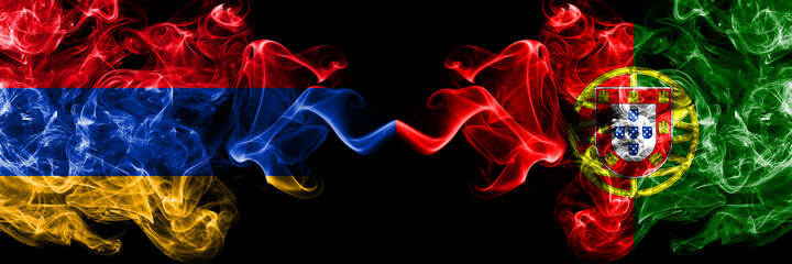 Armenia vs Portugal, Portuguese smoky mystic flags placed side by side. Thick colored silky abstract smoke flags