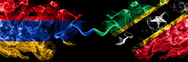 Armenia vs Saint Kitts and Nevis smoky mystic flags placed side by side. Thick colored silky abstract smoke flags