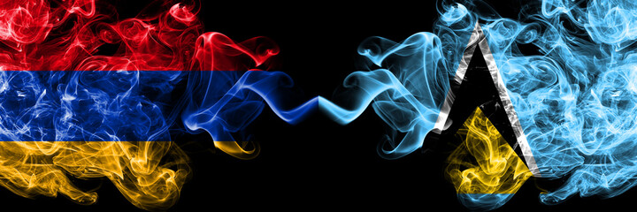 Armenia vs Saint Lucia smoky mystic flags placed side by side. Thick colored silky abstract smoke flags