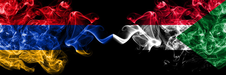 Armenia vs Sudan, Sudanese smoky mystic flags placed side by side. Thick colored silky abstract smoke flags