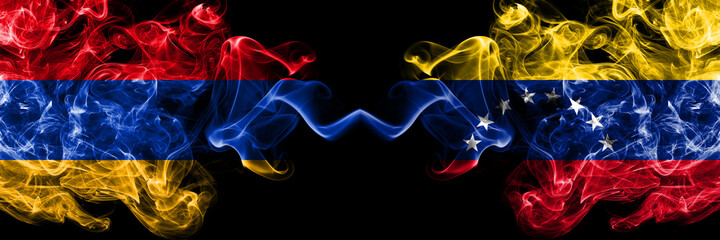 Armenia vs Venezuela, Venezuelan smoky mystic flags placed side by side. Thick colored silky abstract smoke flags