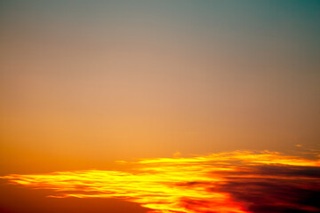 Naklejka na ściany i meble Sky at sunset with bright orange clouds