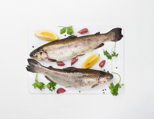 Two raw trouts with spices and lemon