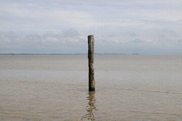 Standing isolated in in the middle of the Wadden Sea on Romo island in Denmark 