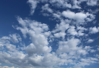 Very beautiful white clouds hover in the dark blue sky