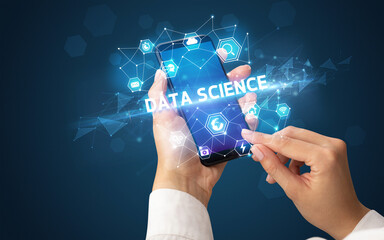 Female hand holding smartphone with DATA SCIENCE inscription, modern technology concept