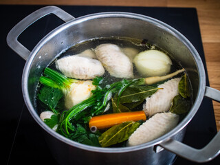 Broth - boiling chicken soup in pot

