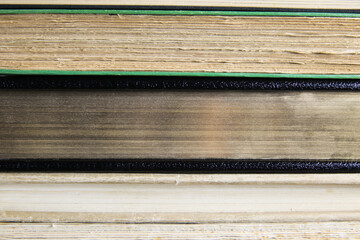 View on fore edge of isolated stacked old yellowed books with copy space for text