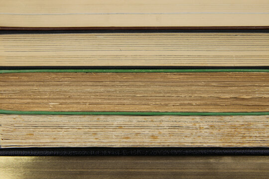 View on fore edge of isolated stacked old yellowed books with copy space for text
