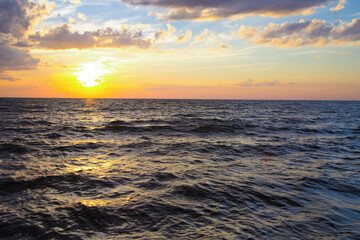 Fototapeta premium Sunset over the coast of Lake Michigan on a beach in the Great Lakes State. 