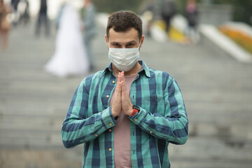 Fototapeta na wymiar Businessman wearing face mask and greeting with namaste to prevent spread of virus. Covid-19.