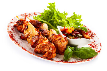 Grilled shashlik with vegetables on white background
