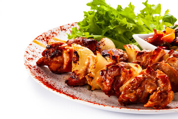 Grilled shashlik with vegetables on white background
