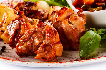 Grilled shashlik with vegetables on white background
