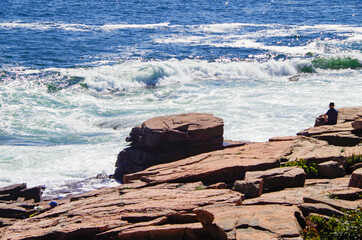 Ocean surf and wash on rocky coast line of Acadia National Park, a popular cruise tour nature...