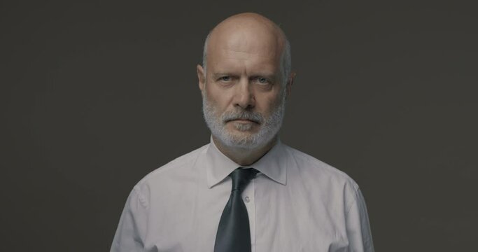 Angry senior business executive shouting at camera