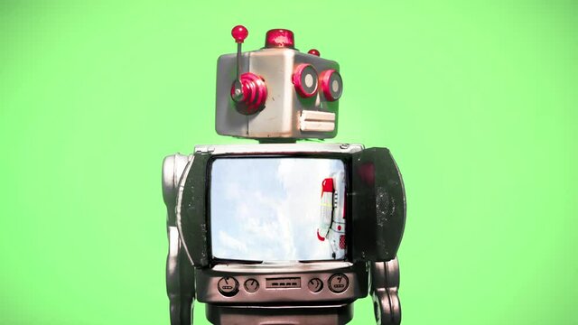 a retro robot with a spinning head and don't panic message  with a green screen background