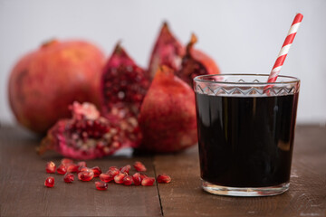Fresh ripe pomegranate and juice in the glass. Close up