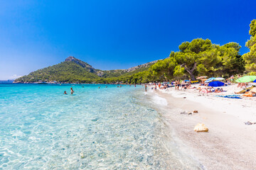 Platja de Formentor, Mallorca, Spain - July 20, 2020: People enjoying popular beach in summer, Mallorca, Spain.
