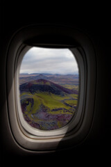 Fototapeta premium Airplane interior with window view of a volcano in the highlands of Iceland