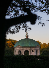 Munich hofgarden cathedral during sunset, framed by trees