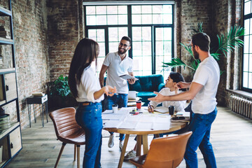 Multiethnic colleagues working on project together in modern office