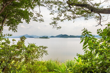 Lake Mutanda with view on the volcanoes mount Muhavuru and mount Gahinga in East Africa, along the border of Rwanda and Uganda.