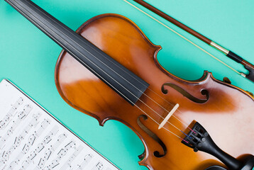 Violin body with bow and Musical score on a green background
