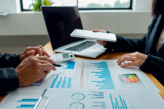 A Male Businessman And A Female Finance Department Head Are Explaining And Calculating The Company's Turnover In The Office.