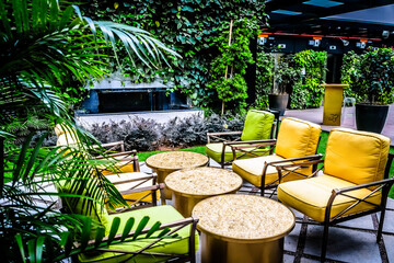 Outdoor garden deck chairs and coffee tables in an outdoor rooftop garden