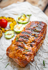 grilled meat ribs with vegetables on wooden table