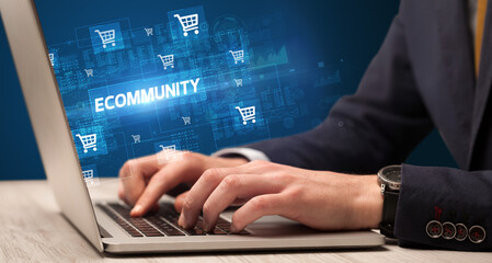 Obraz na płótnie Canvas Businessman working on laptop with ECOMMUNITY inscription, online shopping concept