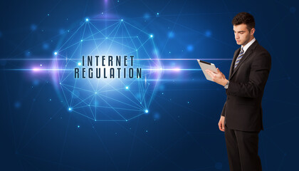 Businessman thinking about security solutions with INTERNET REGULATION inscription