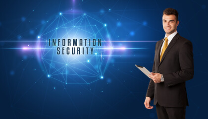 Businessman thinking about security solutions with INFORMATION SECURITY inscription