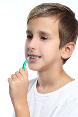 Happy boy cleaning brace by interdental brush