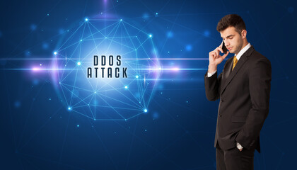 Businessman thinking about security solutions with DDOS ATTACK inscription