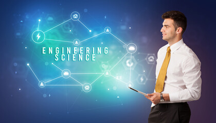Businessman in front of cloud service icons with ENGINEERING SCIENCE inscription, modern technology concept