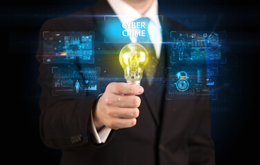Businessman holding lightbulb with CYBER CRIME inscription, online security idea concept