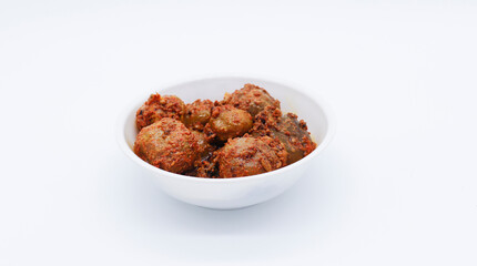 Homemade Gooseberry or amla Pickle or Aavle ka Achar in a bowl or barni on white background. side angle shot