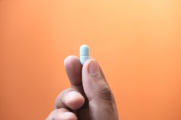 Close up of man hand taking medicine 