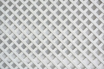 white lattice diagonal pattern on white wall background 