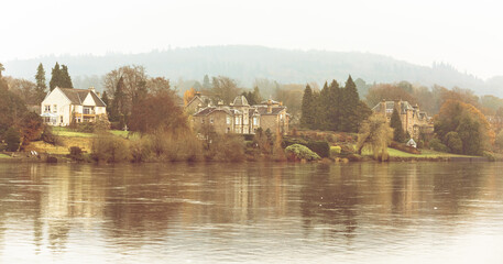 Fototapeta premium Perth, Scotland - 24 November 2019: old stone built houses along the river