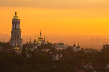 Naklejka premium Golden dawn at Kiev/Kyiv. View of the Kiev Pechersk Lavra and the left bank