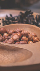 Hazelnuts in a wooden bowl. Autumn background.